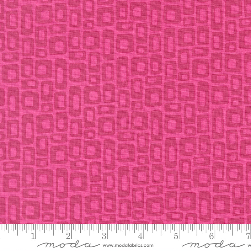 Pink fabric pattern with a ruler at the bottom for scale