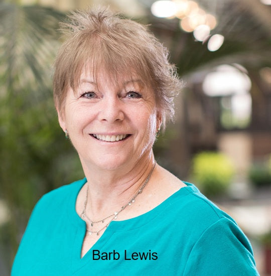 Headshot of instructor Barb Lewis wearing a teal top, smiling in front of a softly blurred green background.