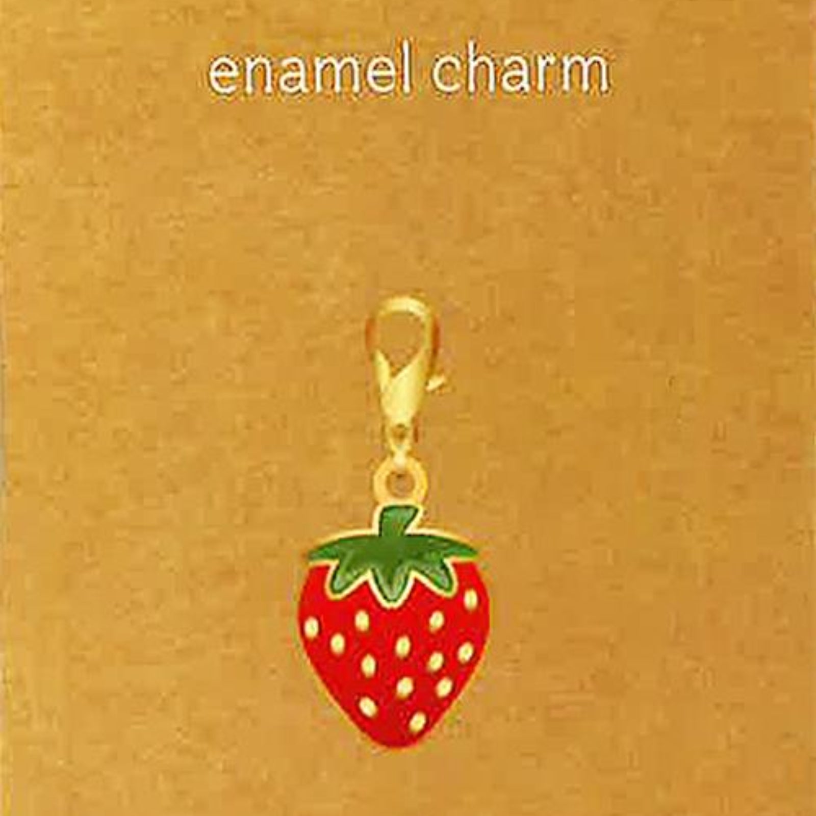 A strawberry-shaped enamel charm with a gold lobster clasp, displayed on a brown kraft card that reads 'enamel charm' and 'JEWELRY MADE BY ME'.