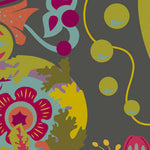 A close-up of a colorful abstract floral and botanical pattern on a dark gray background, featuring yellow-green circles, teal leaves, magenta flowers, and orange accents.
