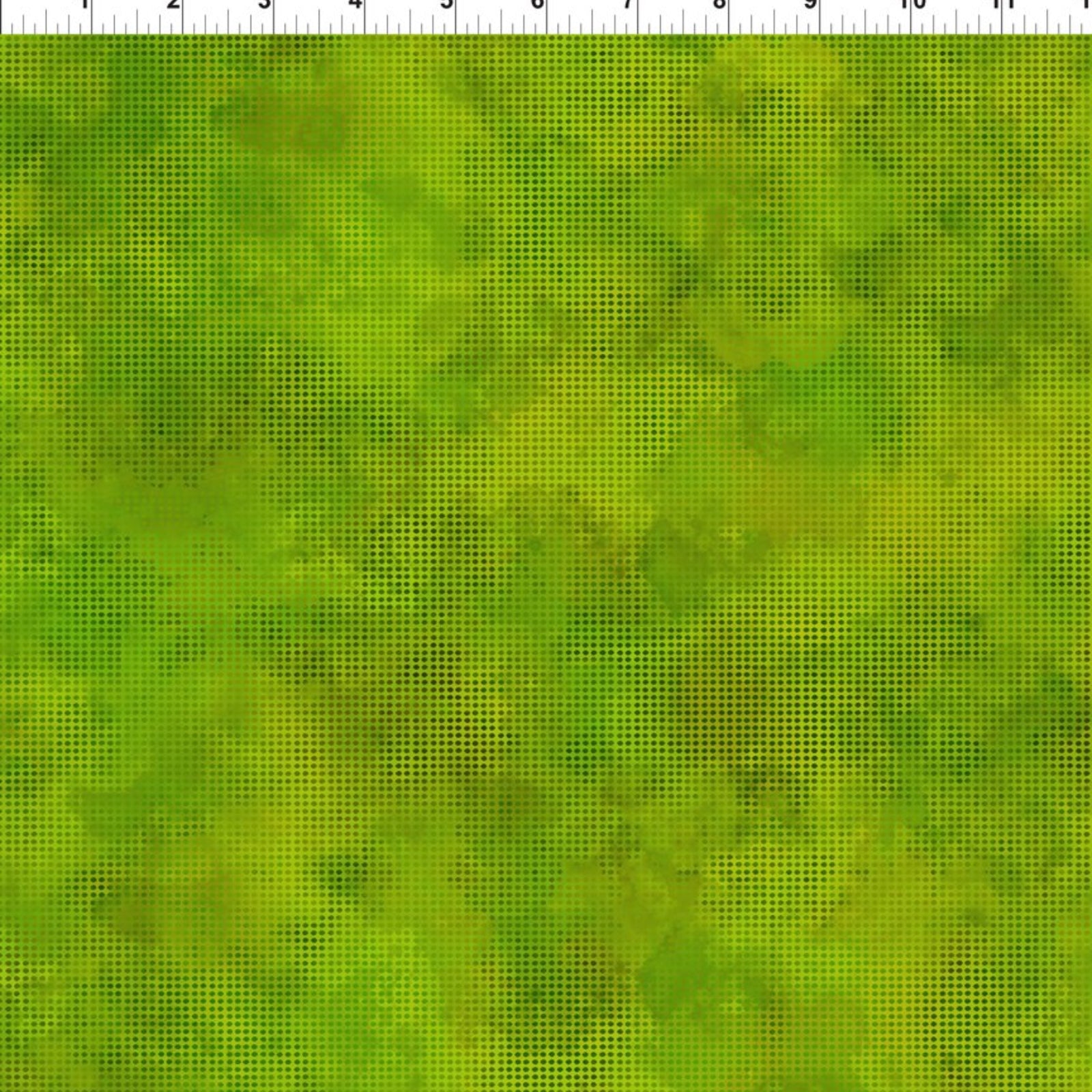 A close-up of a green marbled or mottled textured fabric with a ruler scale visible along the top edge.