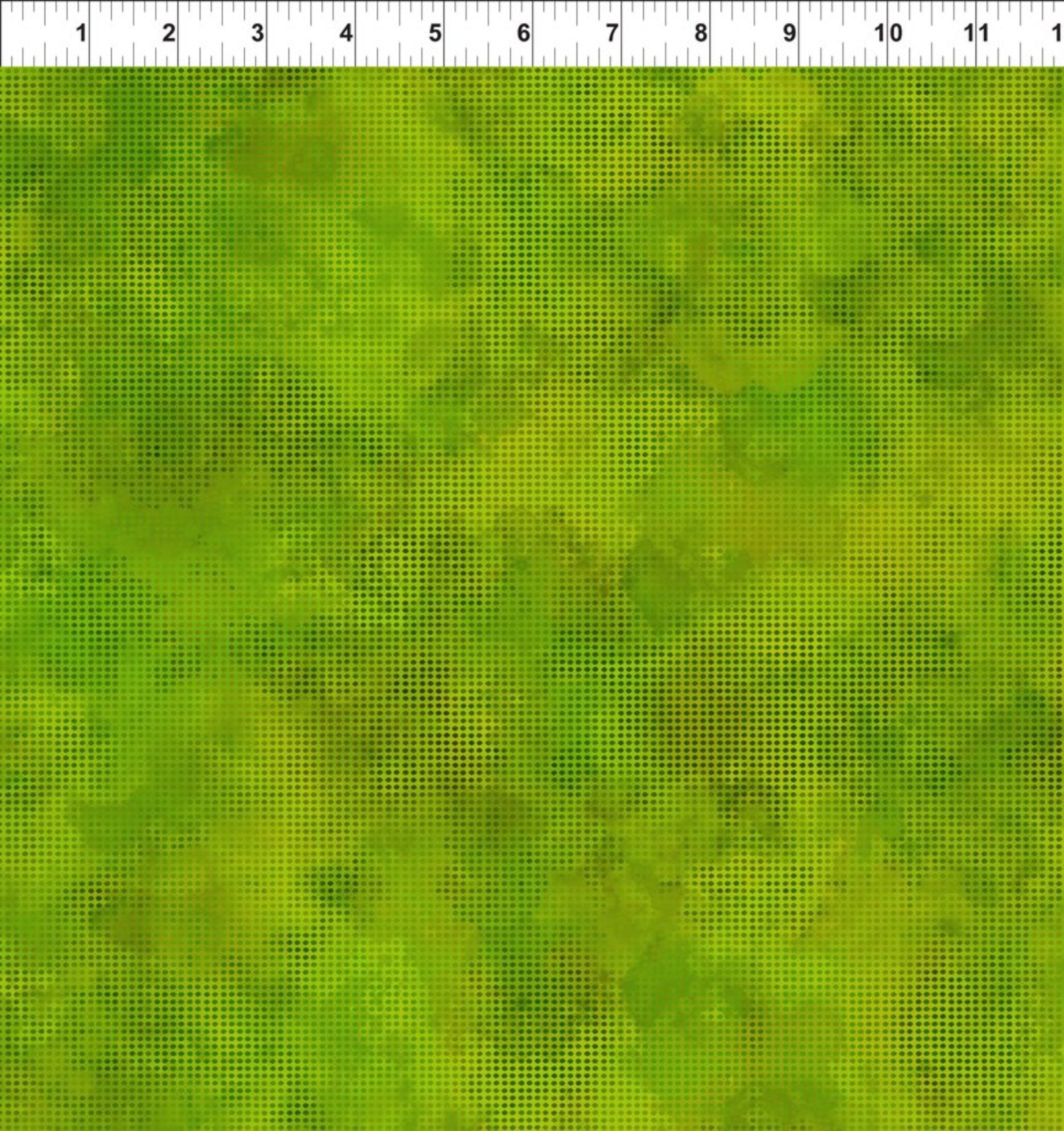 A close-up of a green marbled or mottled textured fabric with a ruler scale visible along the top edge.