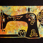 Decorative black sewing machine silhouette with floral cutouts on a vibrant multicolor appliqué background