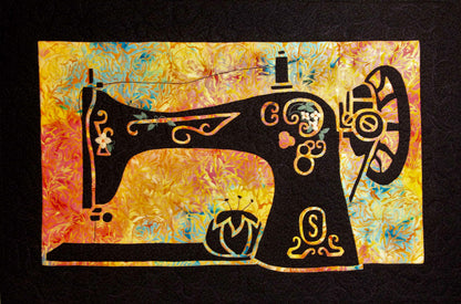 Decorative black sewing machine silhouette with floral cutouts on a vibrant multicolor appliqué background