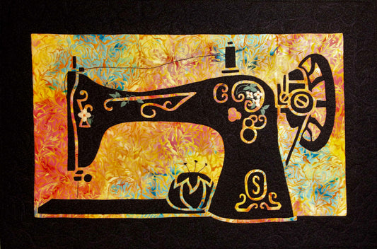 Decorative black sewing machine silhouette with floral cutouts on a vibrant multicolor appliqué background