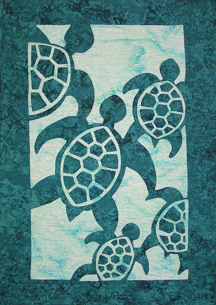 Appliqué quilt featuring five stylized sea turtles in dark teal on a lighter aqua background.