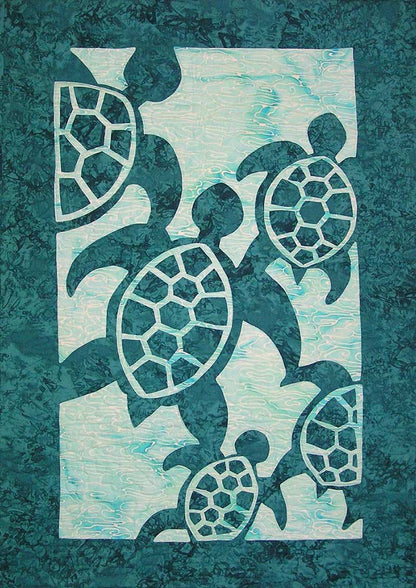 Appliqué quilt featuring five stylized sea turtles in dark teal on a lighter aqua background.