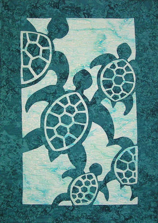 Appliqué quilt featuring five stylized sea turtles in dark teal on a lighter aqua background.
