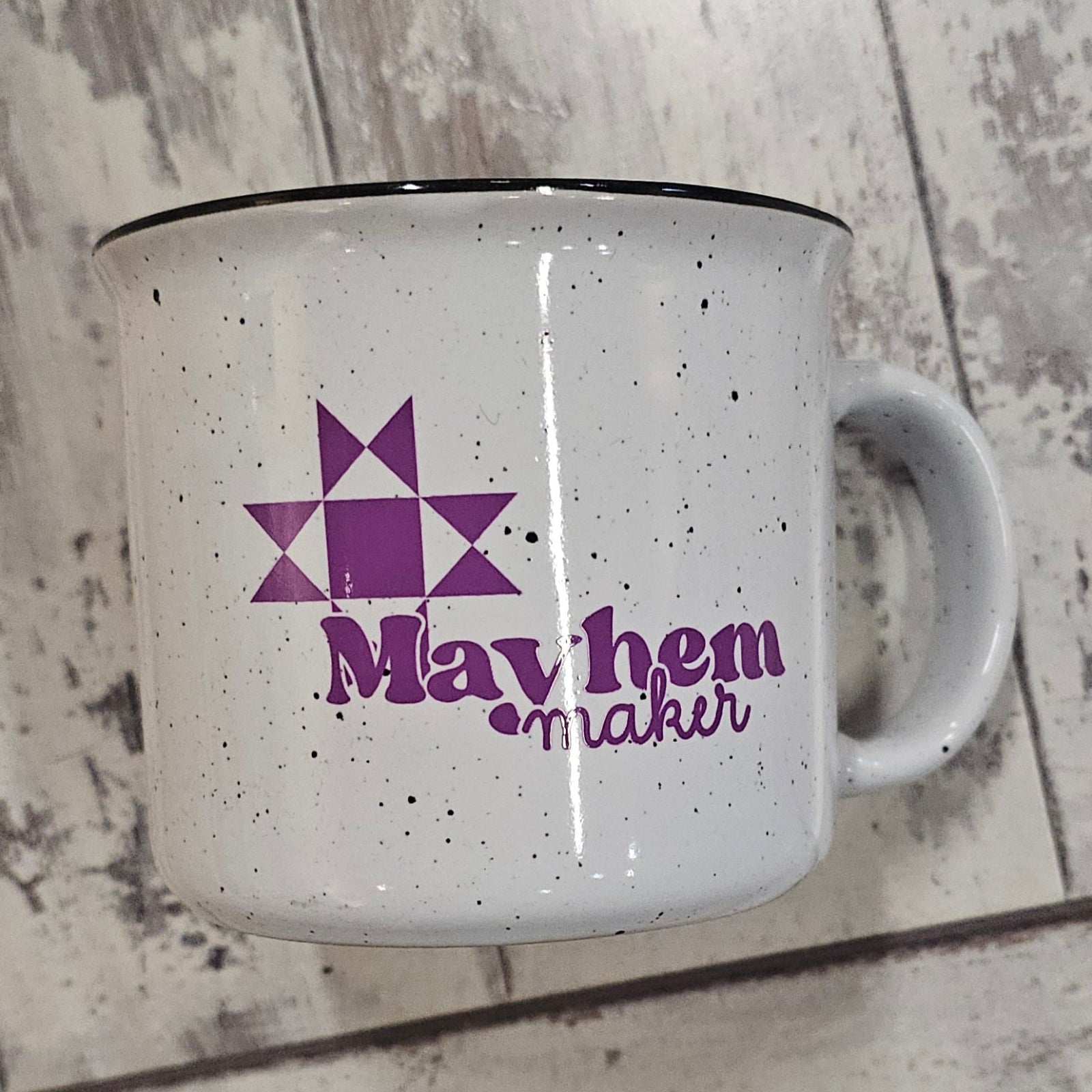 White speckled mug with purple Mayhem maker logo 