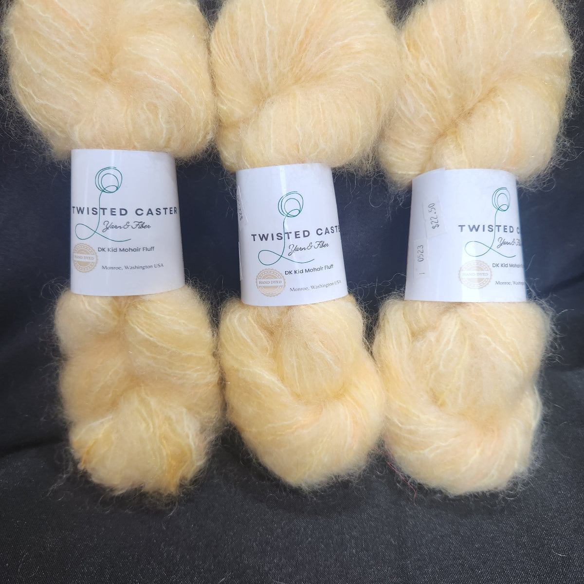 Three skeins of fluffy pale buttery yellow yarn 