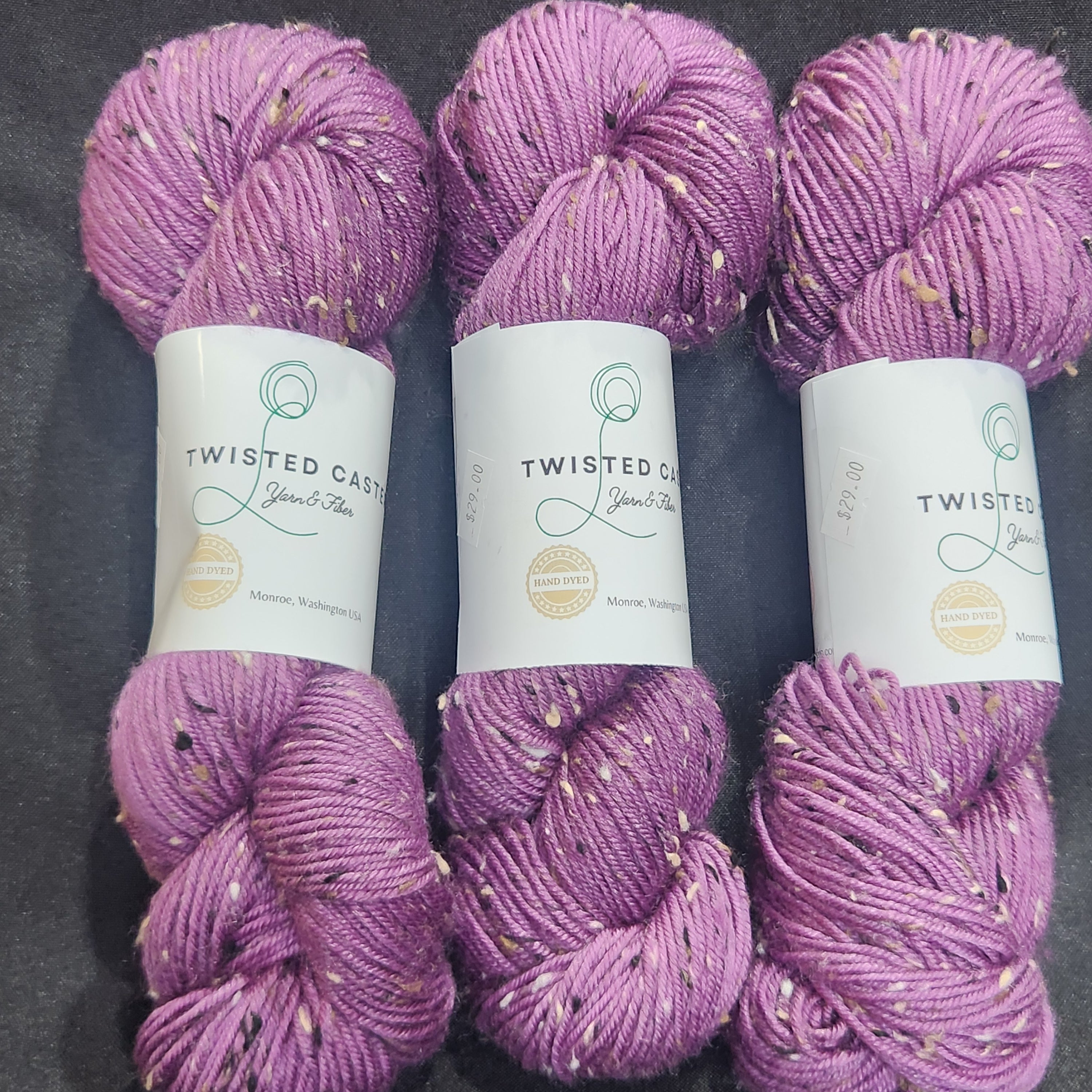 Three skeins of lavender purple variegated yarn.