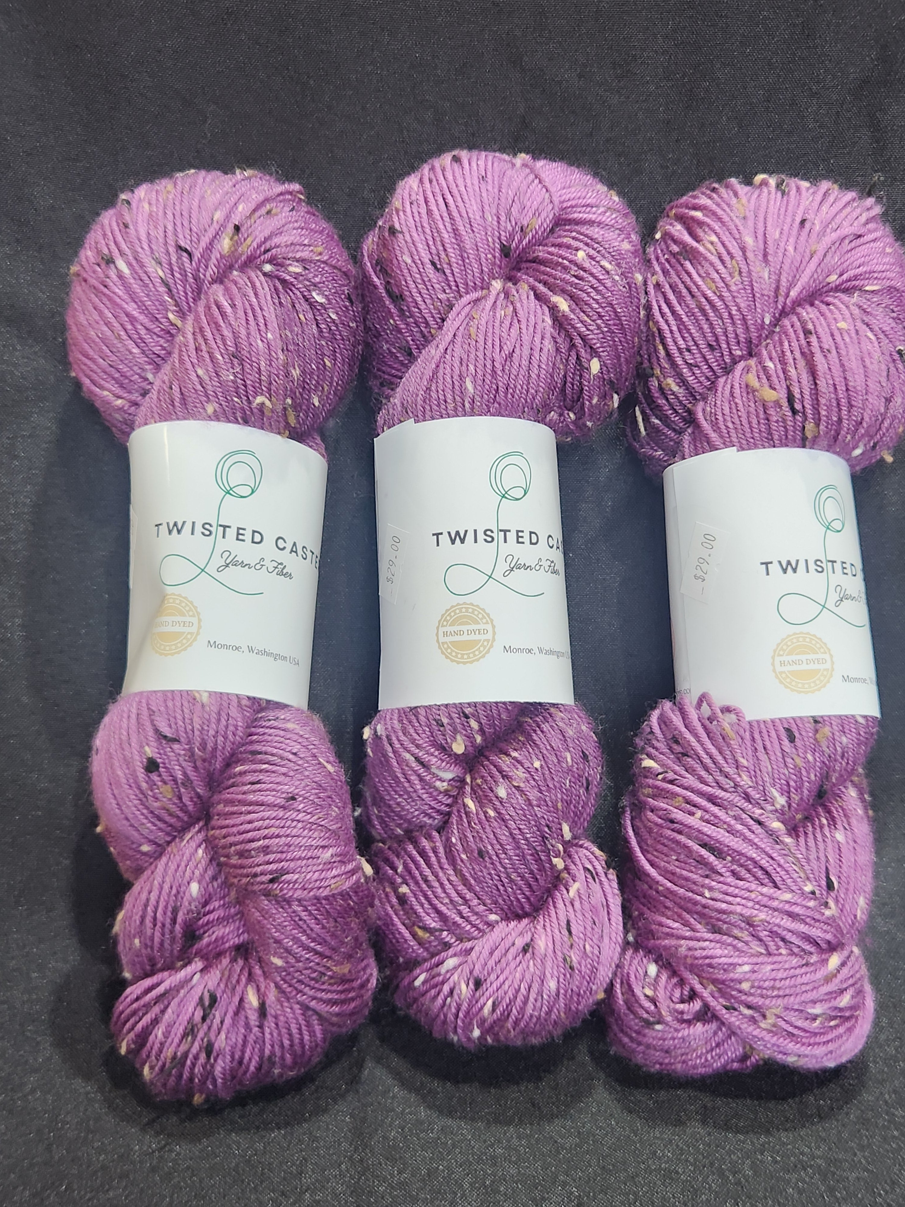 Three skeins of lavender purple variegated yarn.