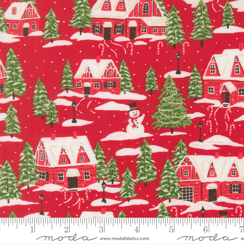 Christmas-themed fabric pattern with houses, trees, and a snowman on a red background, featuring a ruler at the bottom.