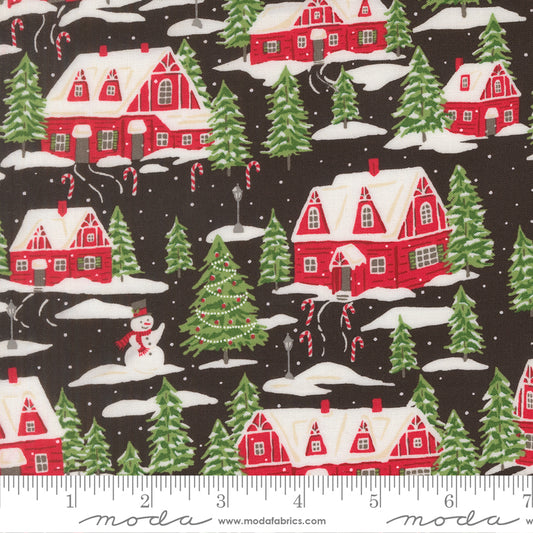 Christmas-themed fabric pattern with red houses, green trees, and snowmen on a black background, featuring a ruler for scale