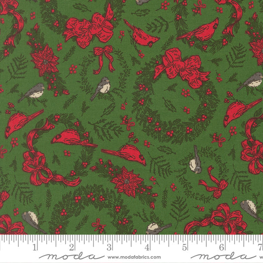 Christmas-themed fabric pattern with red bows, birds, and wreaths on a green background, featuring a ruler for scale.