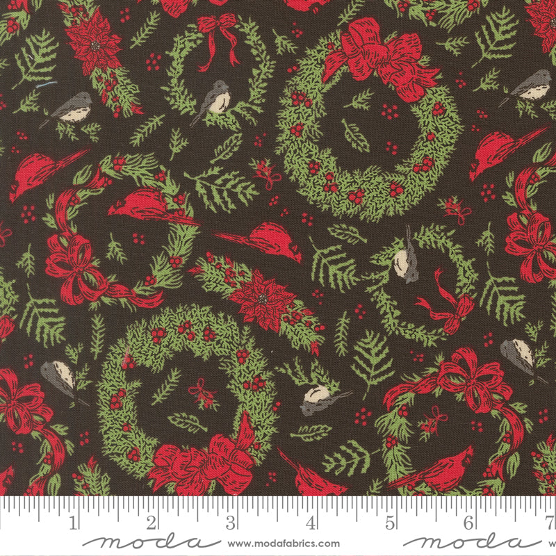 Christmas-themed fabric pattern with wreaths, birds, and red bows on a dark background, featuring a ruler for scale
