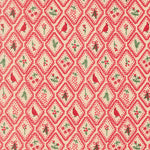 Patterned fabric with red and green design on a beige background