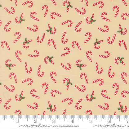 Pattern of red candy canes with green leaves on a beige background, featuring a ruler for scale