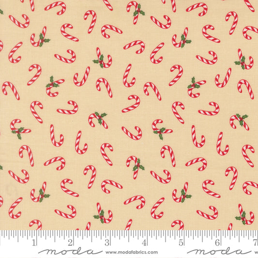 Pattern of red candy canes with green leaves on a beige background, featuring a ruler for scale