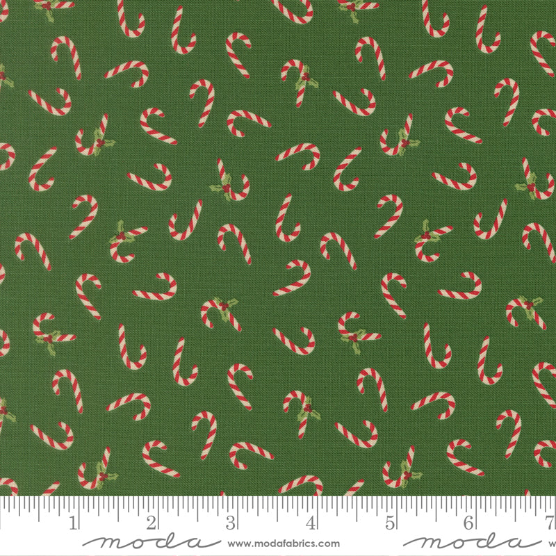 Pattern of candy canes on a green background with a ruler for scale