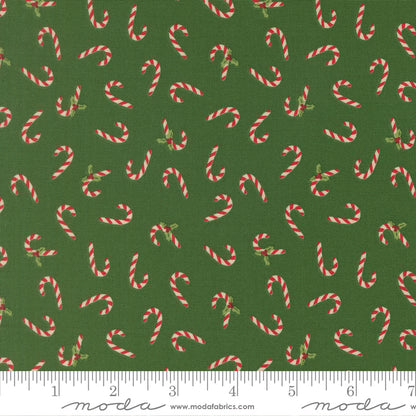 Pattern of candy canes on a green background with a ruler for scale