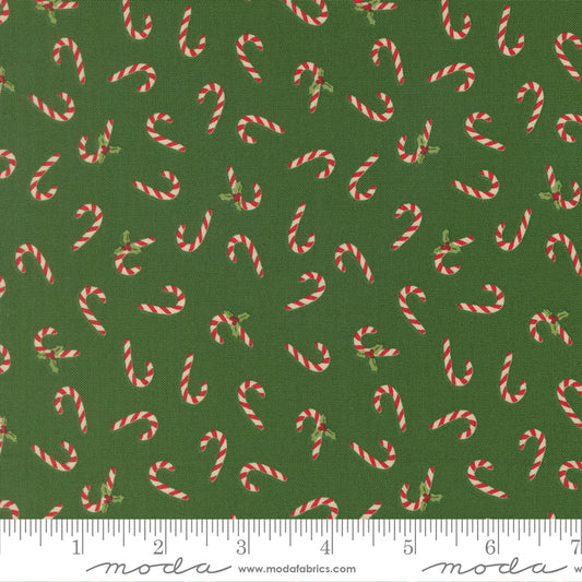 Pattern of candy canes on a green background with a ruler for scale