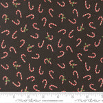 Pattern of candy canes on a black background with a ruler for scale