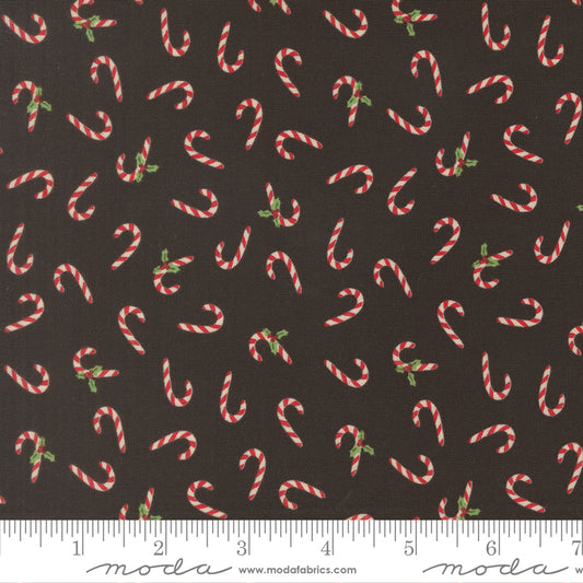 Pattern of candy canes on a black background with a ruler for scale