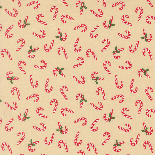 Pattern of red and white candy canes with green leaves on a beige background