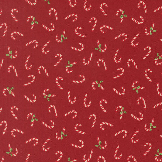 Pattern of candy canes and holly leaves on a red background