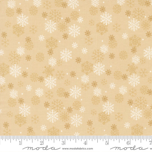 Beige fabric with white and gold snowflake pattern, featuring a ruler for scale
