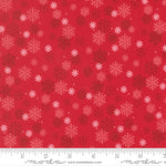 Red fabric with snowflake pattern and ruler for scale