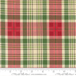 Plaid fabric pattern with red, green, and beige colors, featuring a ruler for scale.