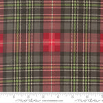 Plaid fabric pattern with a ruler at the bottom for scale, featuring red, green, and black colors.