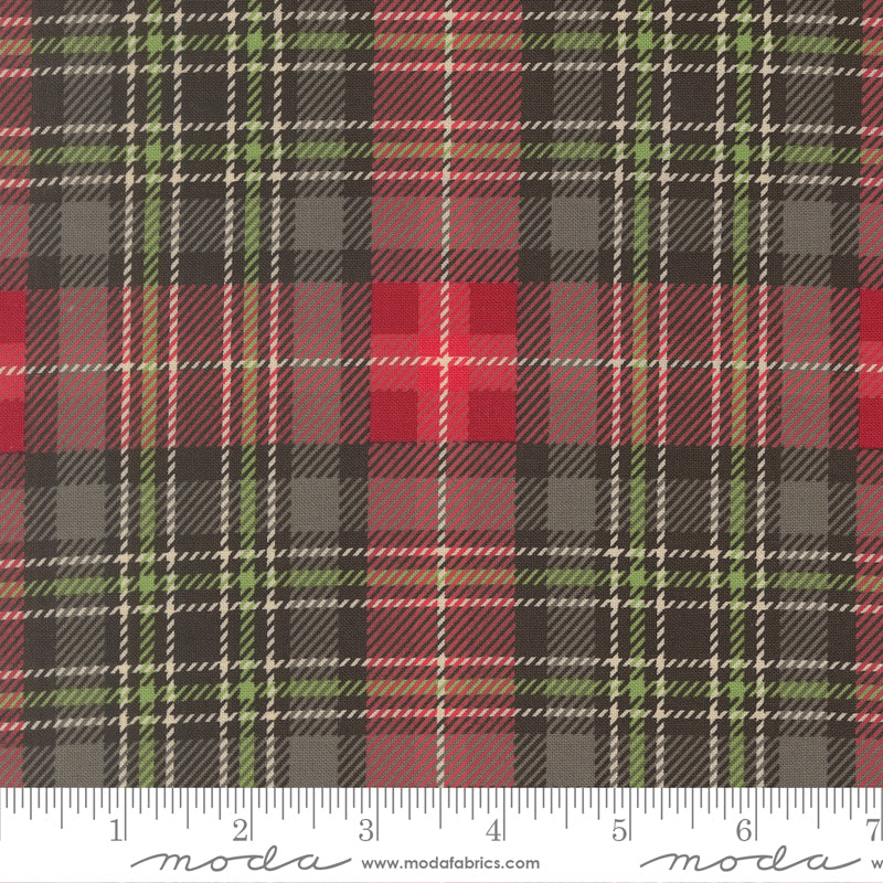 Plaid fabric pattern with a ruler at the bottom for scale, featuring red, green, and black colors.