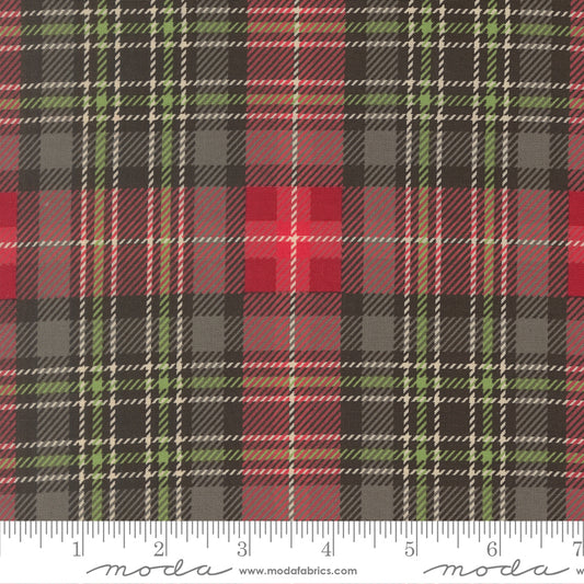 Plaid fabric pattern with a ruler at the bottom for scale, featuring red, green, and black colors.