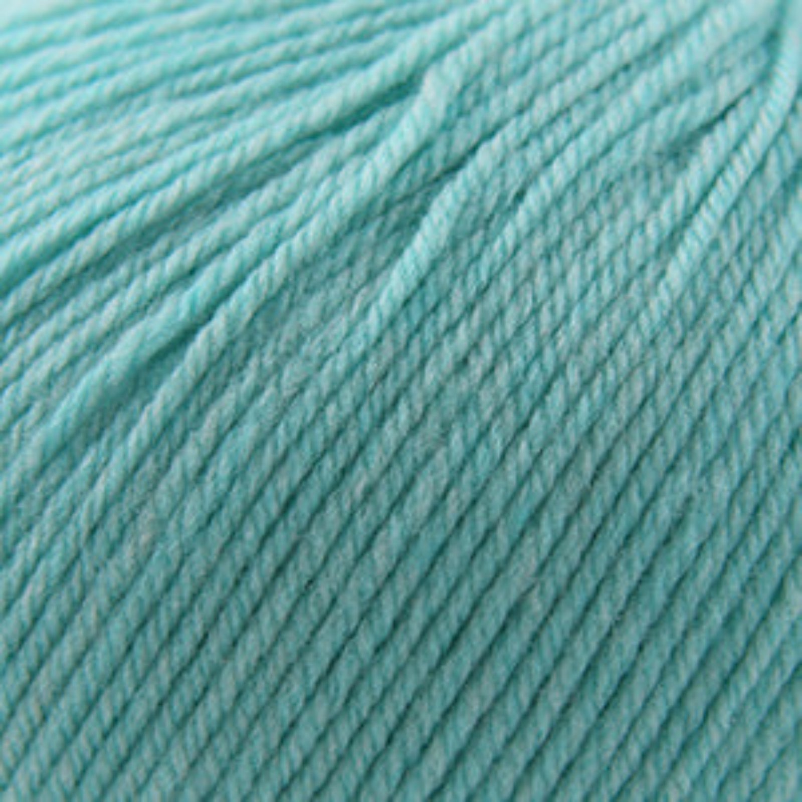 Close-up of teal yarn with a soft texture