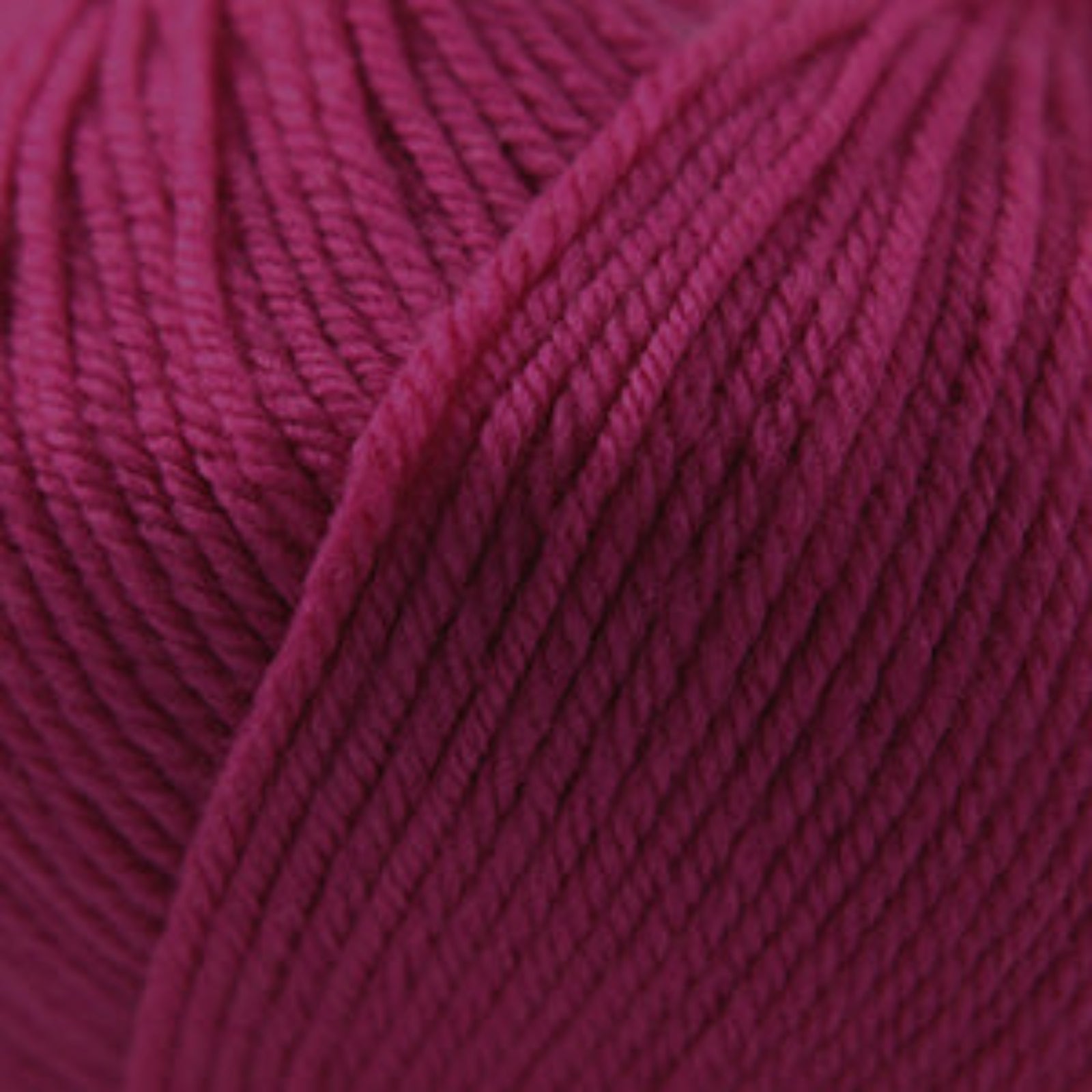 Close-up of a ball of dark pink yarn