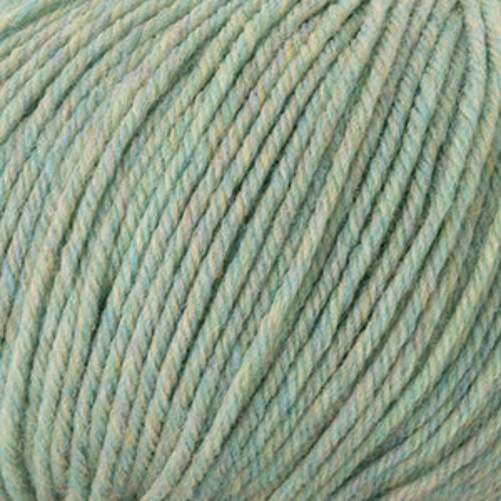 A close-up of twisted yarn strands in a soft, pale mint green color with subtle cream undertones.