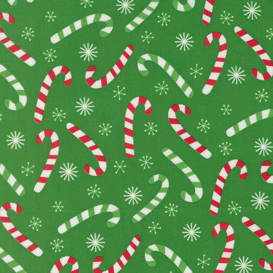 Pattern of candy canes and snowflakes on a green background