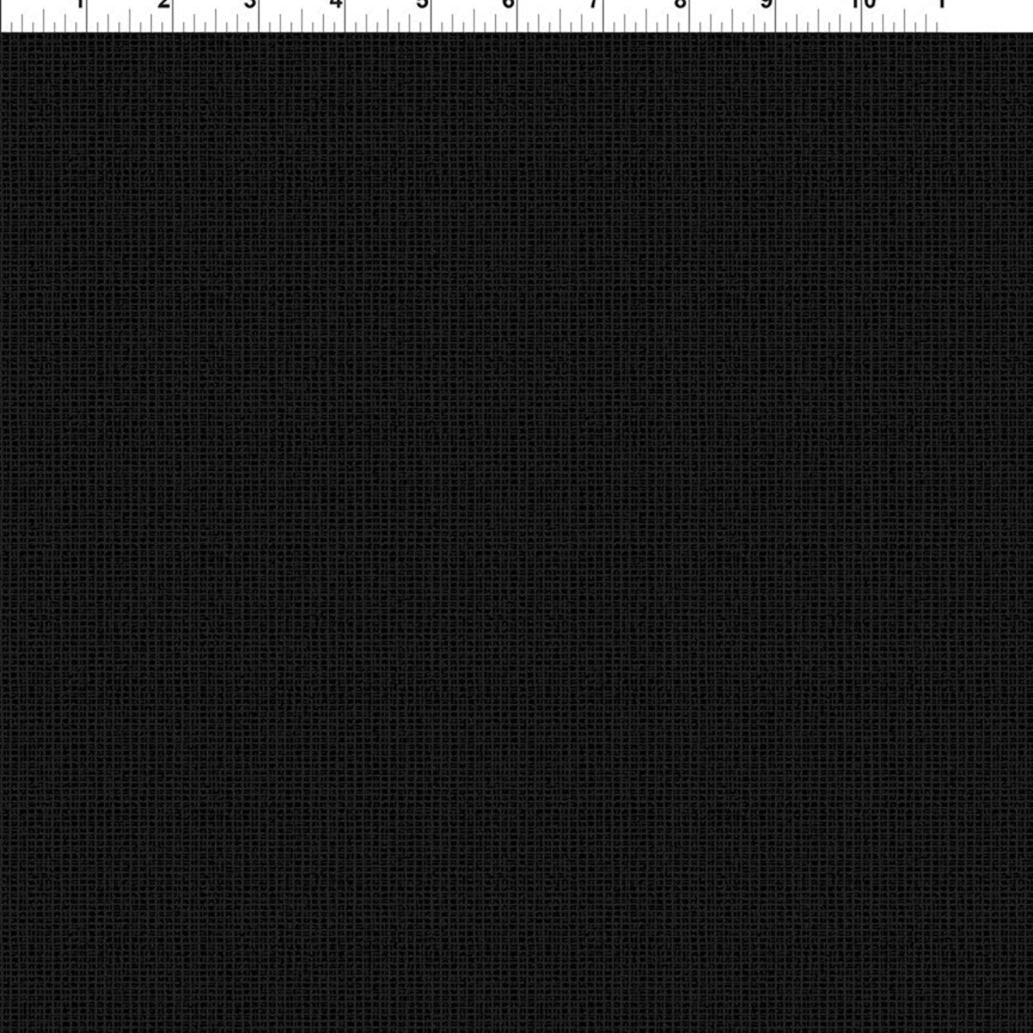 A close-up of a black textured fabric with a fine woven grid pattern, featuring a white ruler scale at the top edge for measurement reference.