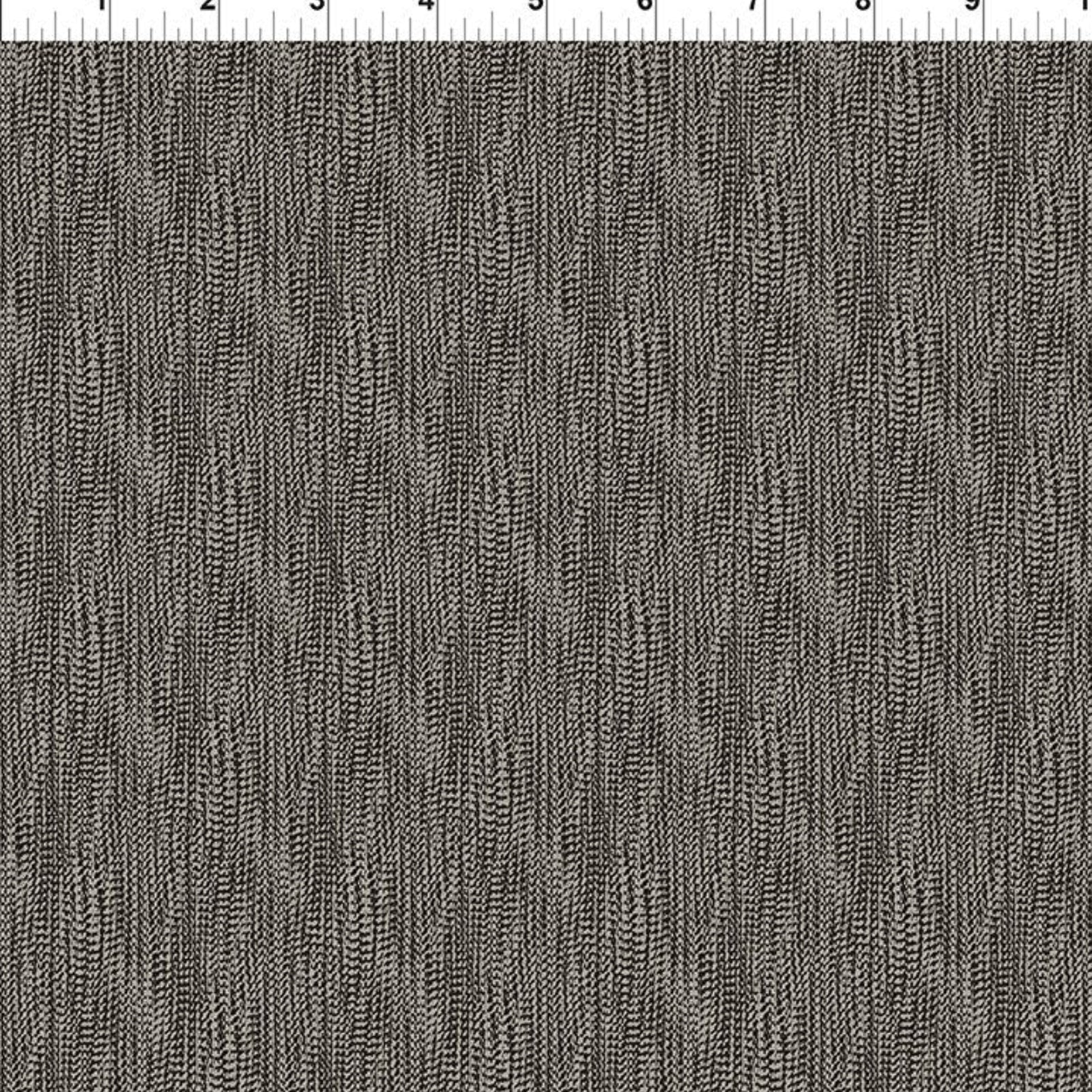 A close-up fabric swatch showing a dark gray and black textured vertical stripe pattern, with a white ruler marked in inches along the top edge.