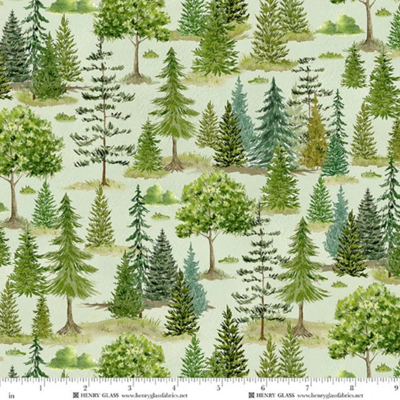 Watercolor-style forest pattern fabric with green and blue-green pine trees on a pale sage background, shown with a ruler at the bottom indicating scale. Brand text 'HENRY GLASS' is visible along the bottom edge.