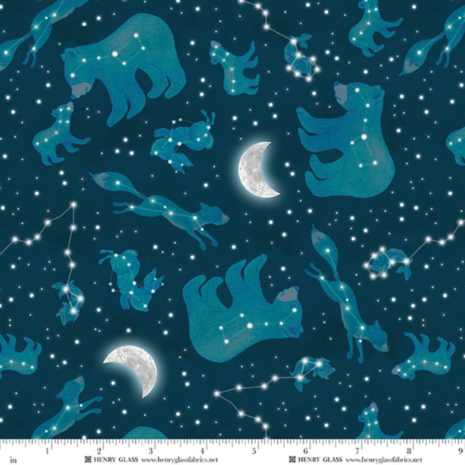 A fabric pattern featuring a dark teal night sky filled with stars, constellations, and crescent moons in shades of blue and teal. A white measurement ruler is visible along the bottom edge with text reading 'HENRY GLASS'.