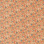 A close-up of a repeating floral pattern with small pink and blue flowers, cream petals, and brown leaves on a warm tan background.