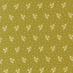 Olive green fabric with a repeating cream pattern of small bows, tiny diamonds, and scattered dots.