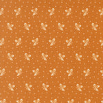 Pattern of small white bows and dots on a brown background