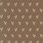 Brown fabric with a repeating pattern of cream-colored bows and small white floral motifs.