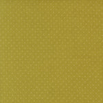 Green fabric with small white polka dots