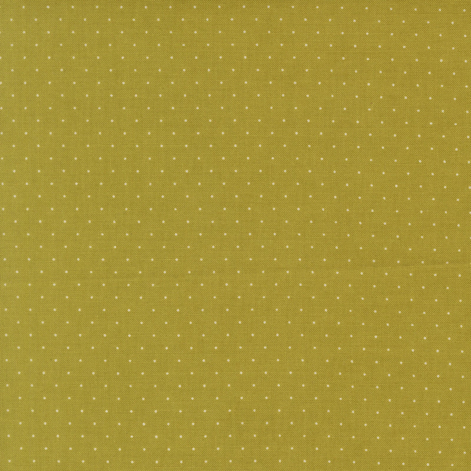 Green fabric with small white polka dots